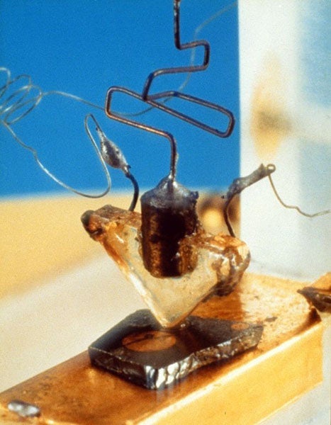 The first transistor of 1947; the silver-gray slab on the bottom is pure germanium, the element discovered by Clemens Winkler in 1886 (Computer History Museum)