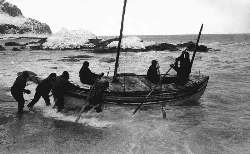 The launch of the <i>James Caird</i> from Elephant Island, Apr. 24, 1916, glass plate photograph by Frank Hurley (Wikipedia)