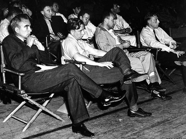 Group photograph (cropped) taken at a symposium at Los Alamos, 1946; Oppenheimer is in the second row, next to Richard Feynman, head down taking notes; Enrico Fermi is just in front of Oppenheimer, in the front row (Wikimedia commons)