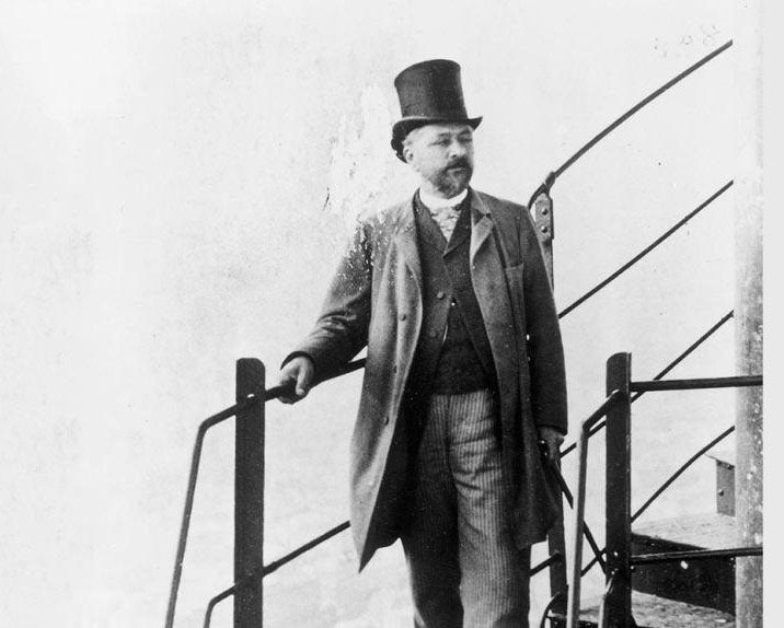 Gustave Eiffel posing on his Tower, undated photograph, official Eiffel Tower website (toureiffel.paris)