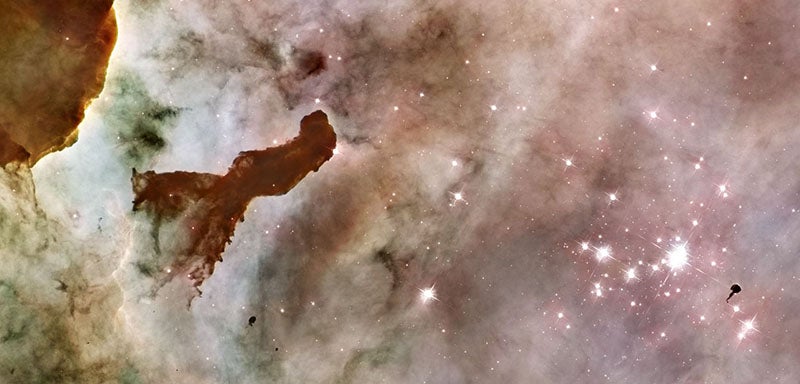 The Carina nebula, with pillar of matter at left and Bok globule at right, in front of star cluster Trumpler 14, image from the Hubble Space Telescope, 2007 (hubblesite.org)