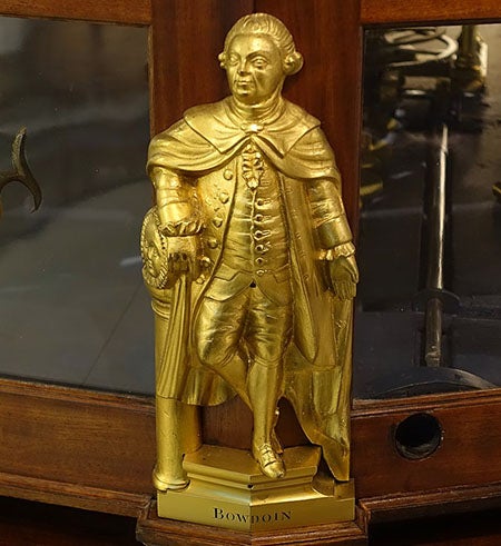 Statuette of James Bowdoin II, brass, possibly by Paul Revere, before 1787, one of four that adorn the base of the Joseph Pope orrery, Putnam Gallery, Harvard University (Wikimedia commons)