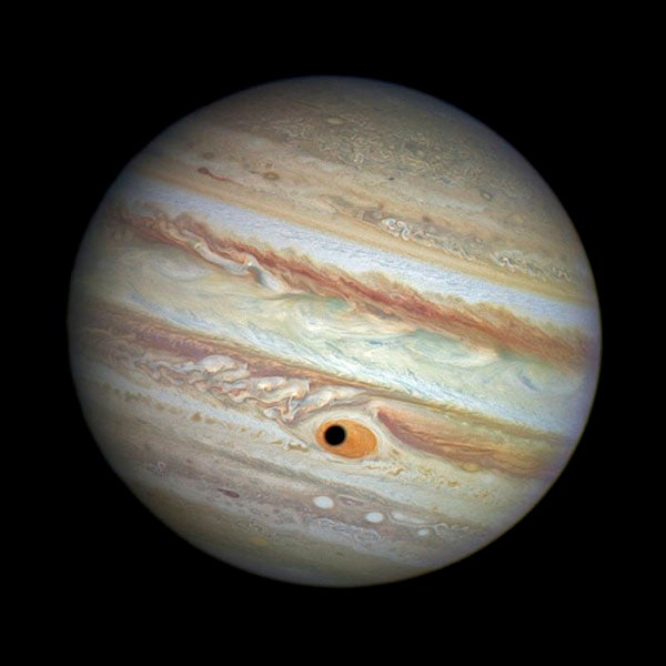 The shadow of Jupiter’s moon Ganymede passing over the Great Red Spot, image from the Hubble Space Telescope, 2014 (cdn.spacetelescope.org)