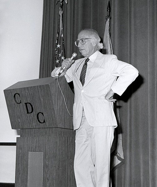 Jonas Salk addressing the Center for Disease Control, photograph, 1988 (Wikimedia commons)