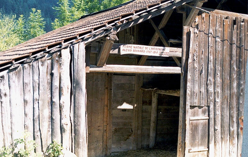 Commemorative plaque, carved in wood, at the “birth farm” of Alexis Bouvard in Les Contamines-Montjoie in the French Alps (Wikimedia commons)