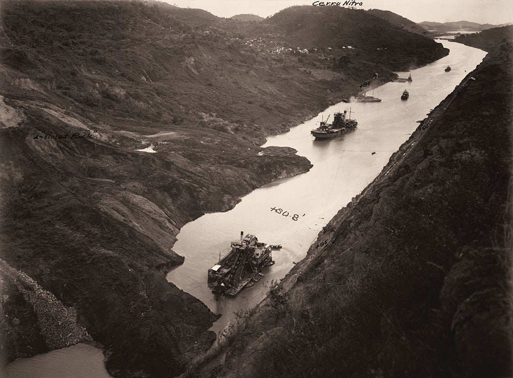 The old French dredge Marmot and the dredge Corozal at work in Culebra Cut, December 3, 1913.
 Though excavation at Culebra Cut was “finished” in May 1913, a slide at Cucaracha still blocked the Canal. Chief Engineer Goethals decided to release water from Lake Gatun in October 1913 to fill the Canal and use dredges to clear the slide.
View in Digital Collection »