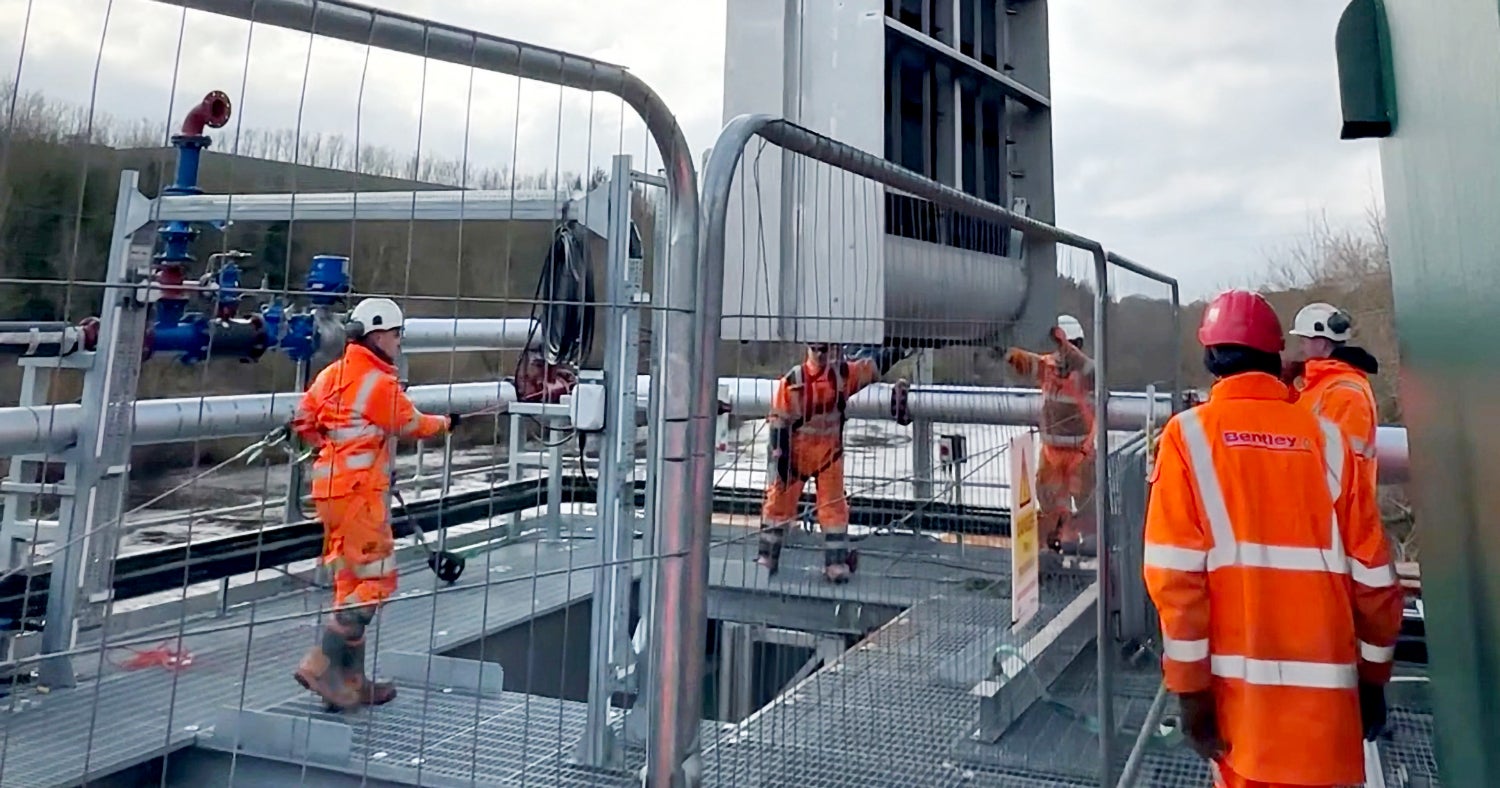 Workers in orange safety gear install Hydrolox screening equipment at the Northumbrian Water River Tyne site.