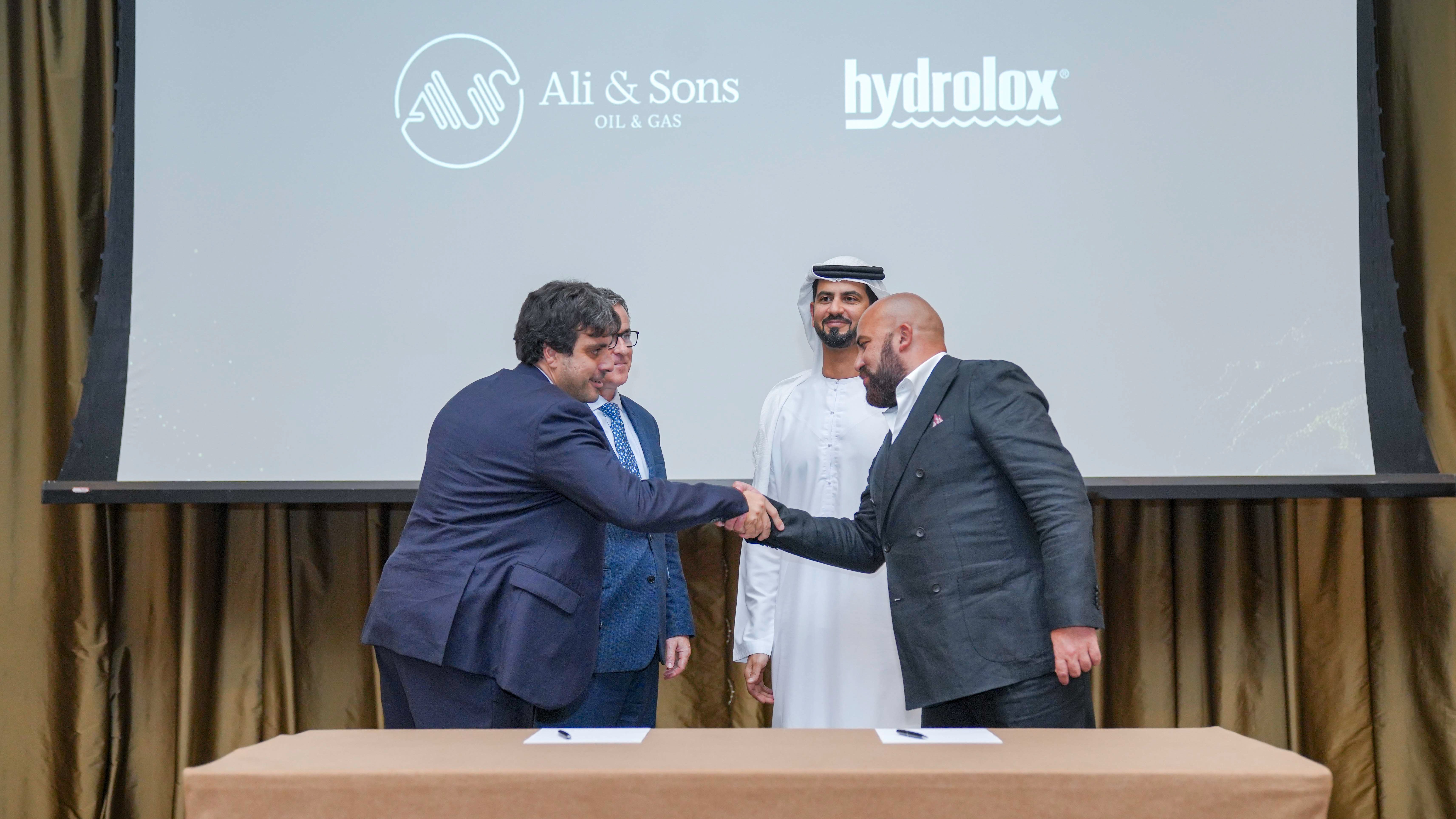 Hydrolox and Ali & Sons officials shaking hands