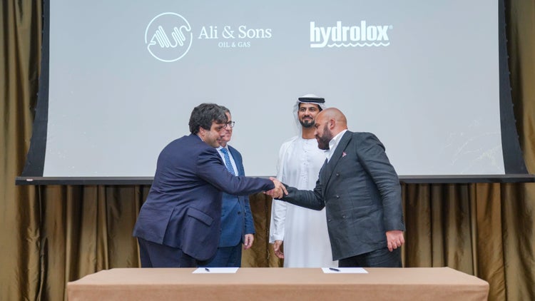 Hydrolox and Ali & Sons officials shaking hands