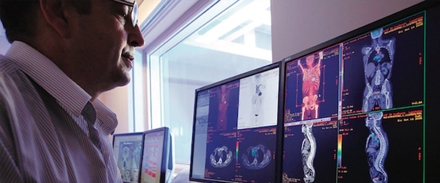 Man looking at scan image on computer screen