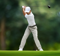 Golfer swinging golf club