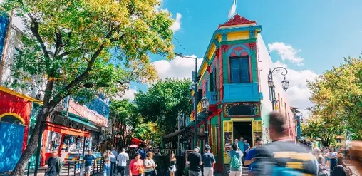 Caminito en La Boca, Buenos Aires, con casas coloridas, turistas y calles adoquinadas.