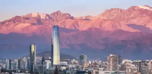 Skyline de Santiago de Chile con el Costanera Center y la Cordillera de los Andes al atardecer.