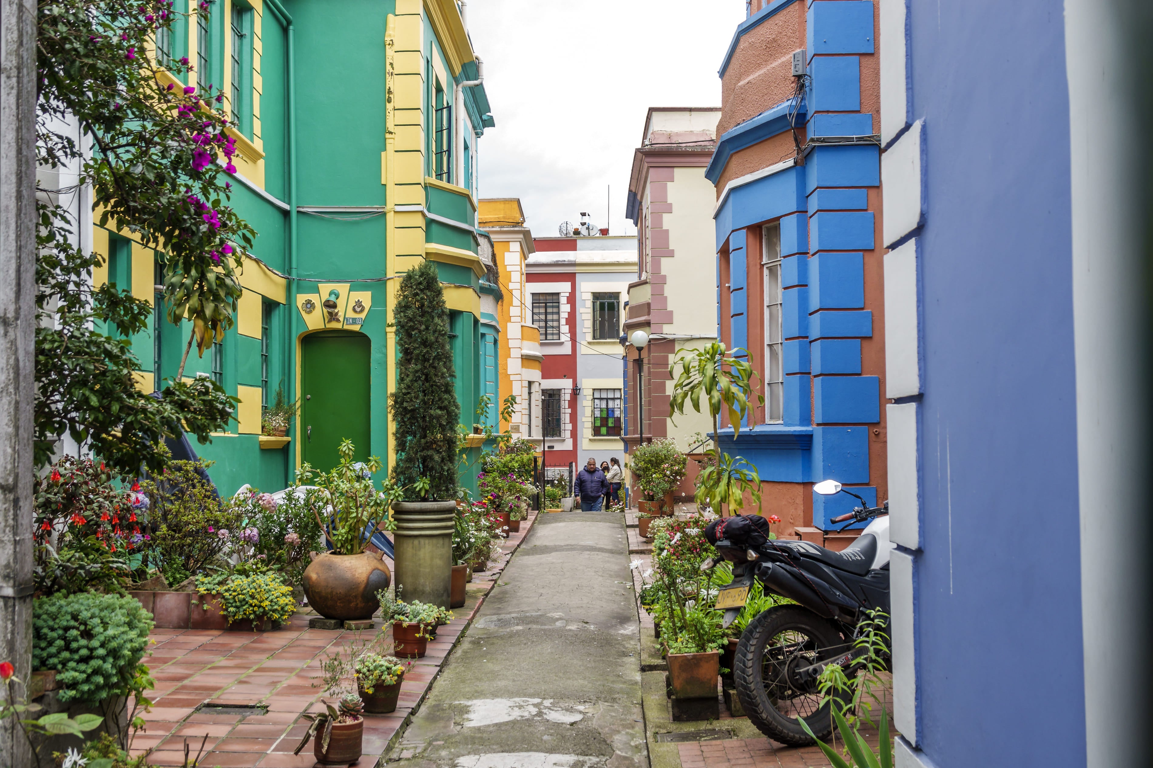 Pasaje peatonal con casas coloridas y jardines en el barrio Teusaquillo de Bogotá, Colombia.