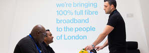 Three fibre engineers talking in room.