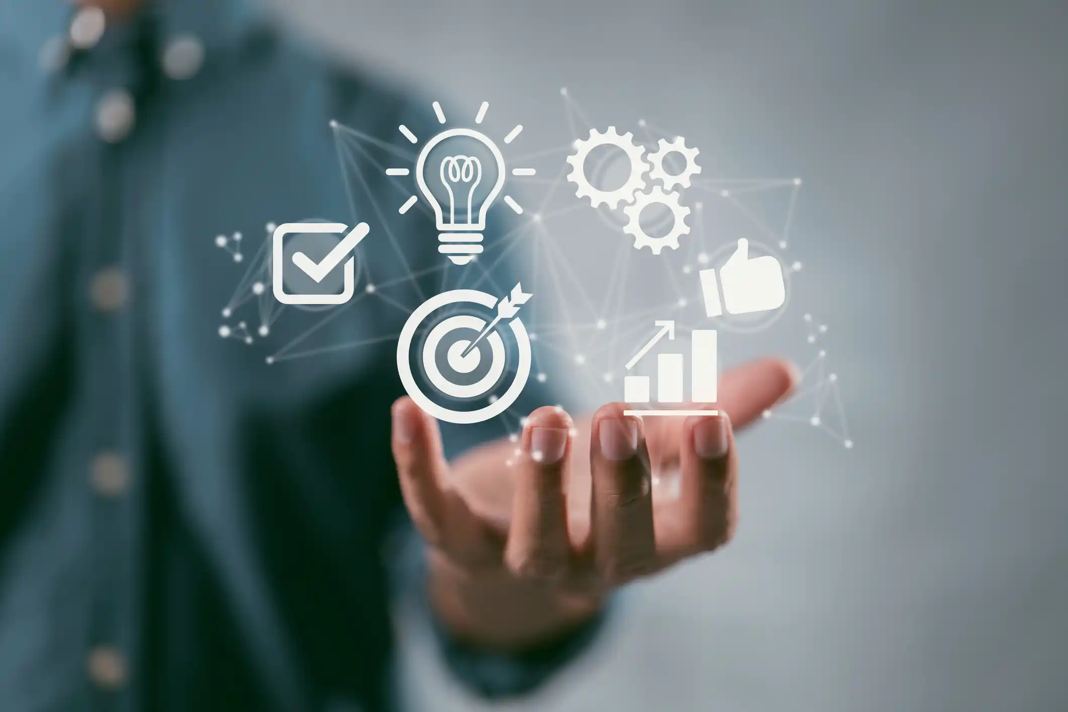 Person holding a hand up with graphics of progress, target, tick boxes, thumbs up and other survey items.