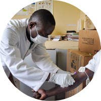 A male medical professional attending to a patient.