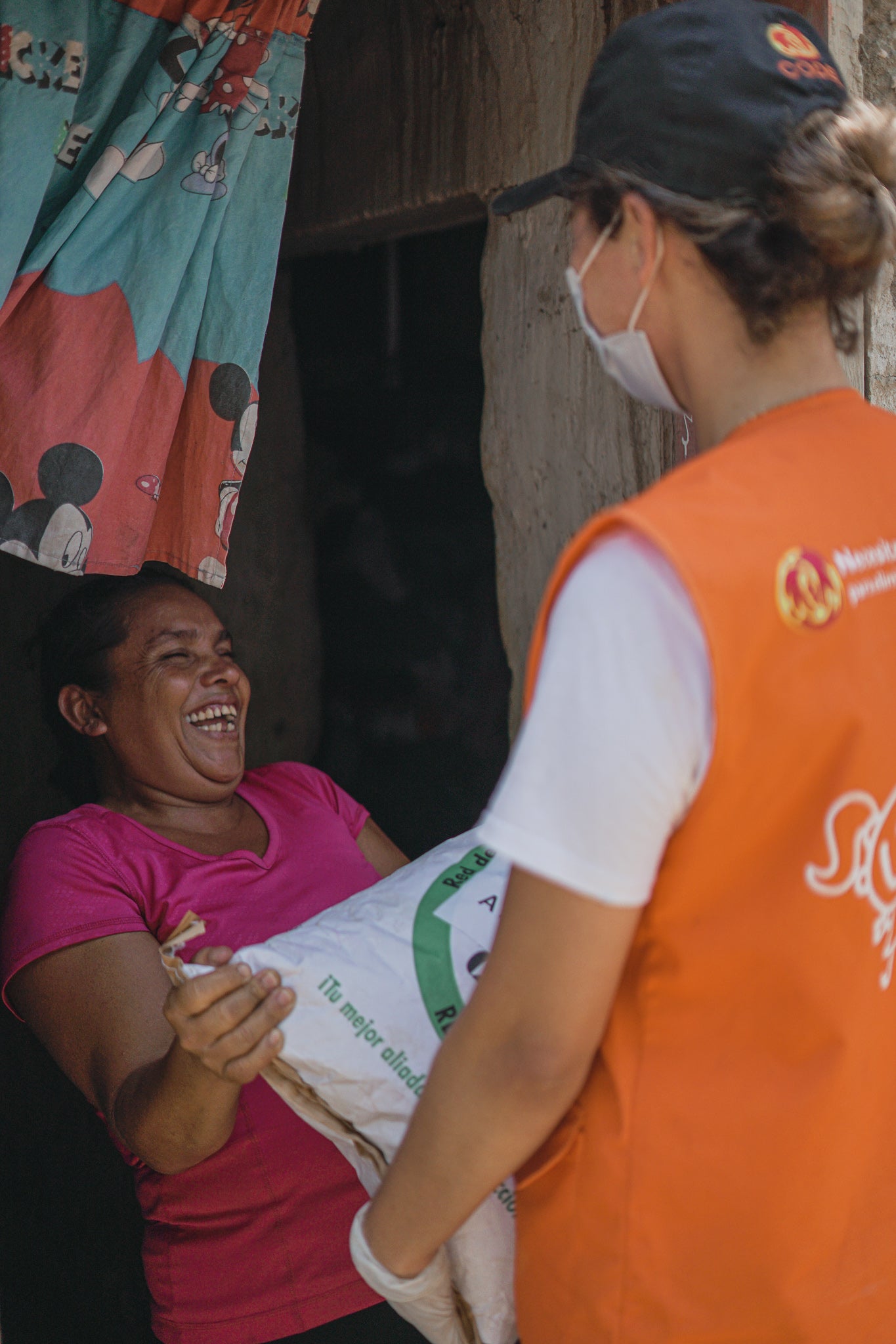 Woman laughs receiving food kit