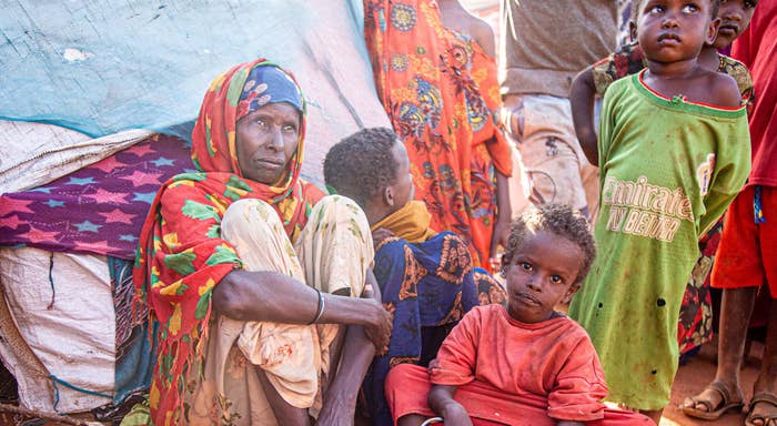 A mother and her children gathered outside a makeshift tent. 