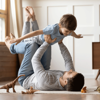 Dad holding his young child up in the air