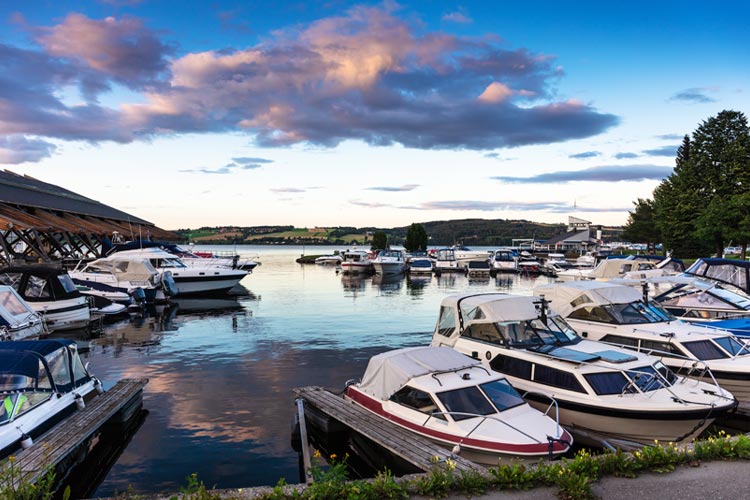 Motor yachts in the port at sunset. If my boat bumps another at a Tennessee marina, who's responsible?