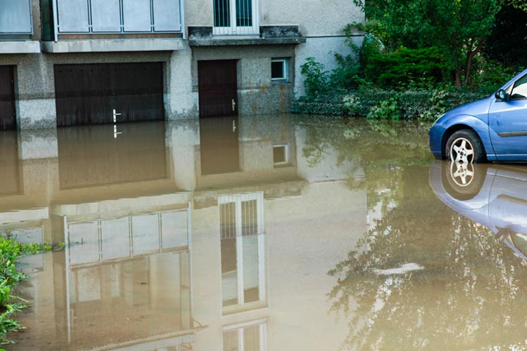 Car in a flood and water to the garage door handle. A how to guide to help prep for Mississippi floods.