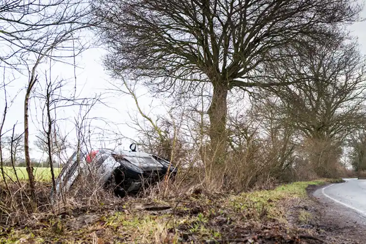A car in a ditch on a countryside road. If a Hurricane Causes a Car Accident, Who's Responsible?