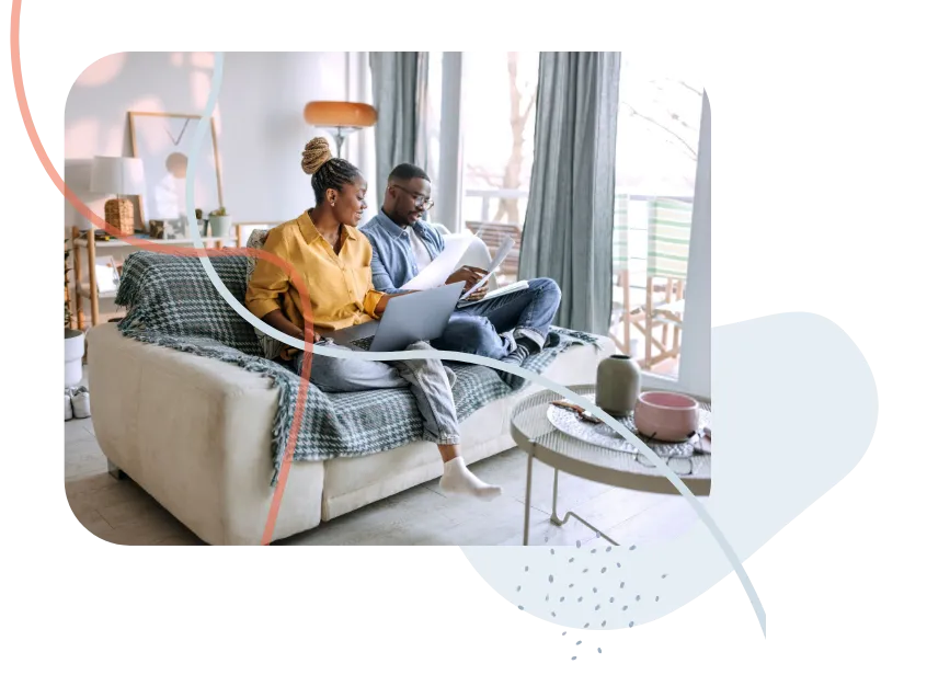 A couple working together on a couch