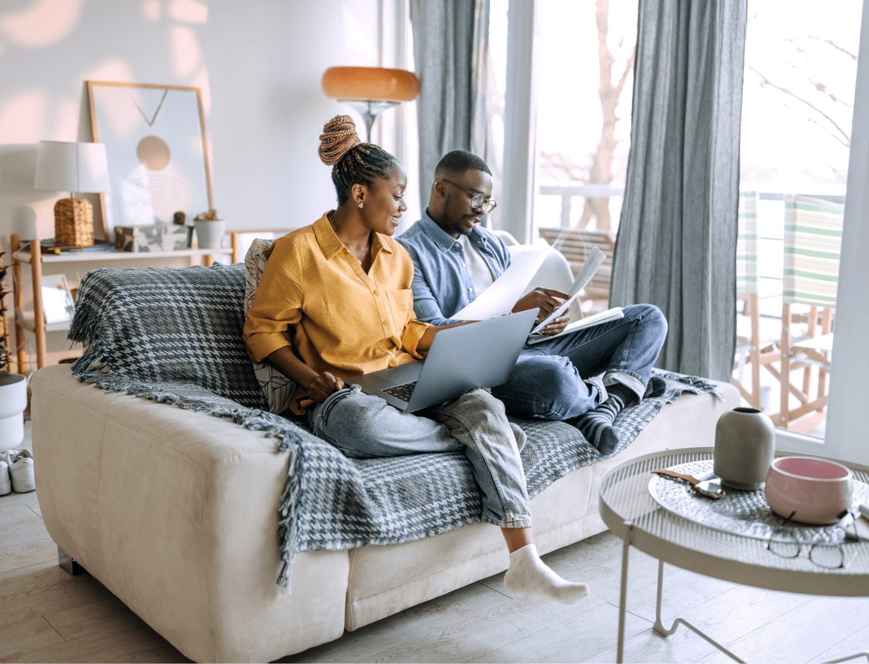 Couple working together on couch