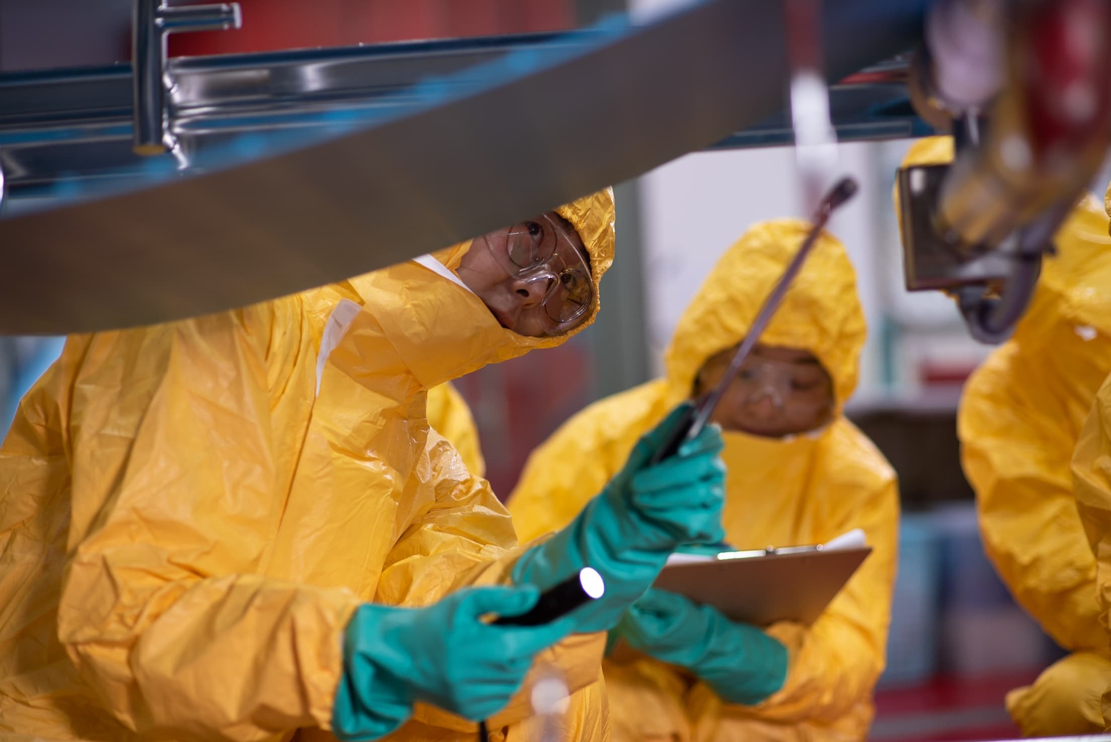team inspecting conveyor system 