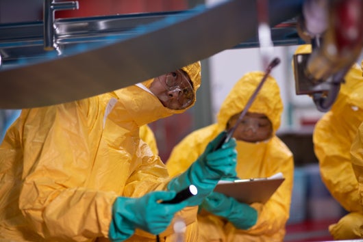 team inspecting conveyor system 