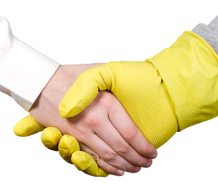 Two hands shaking, one in PPE