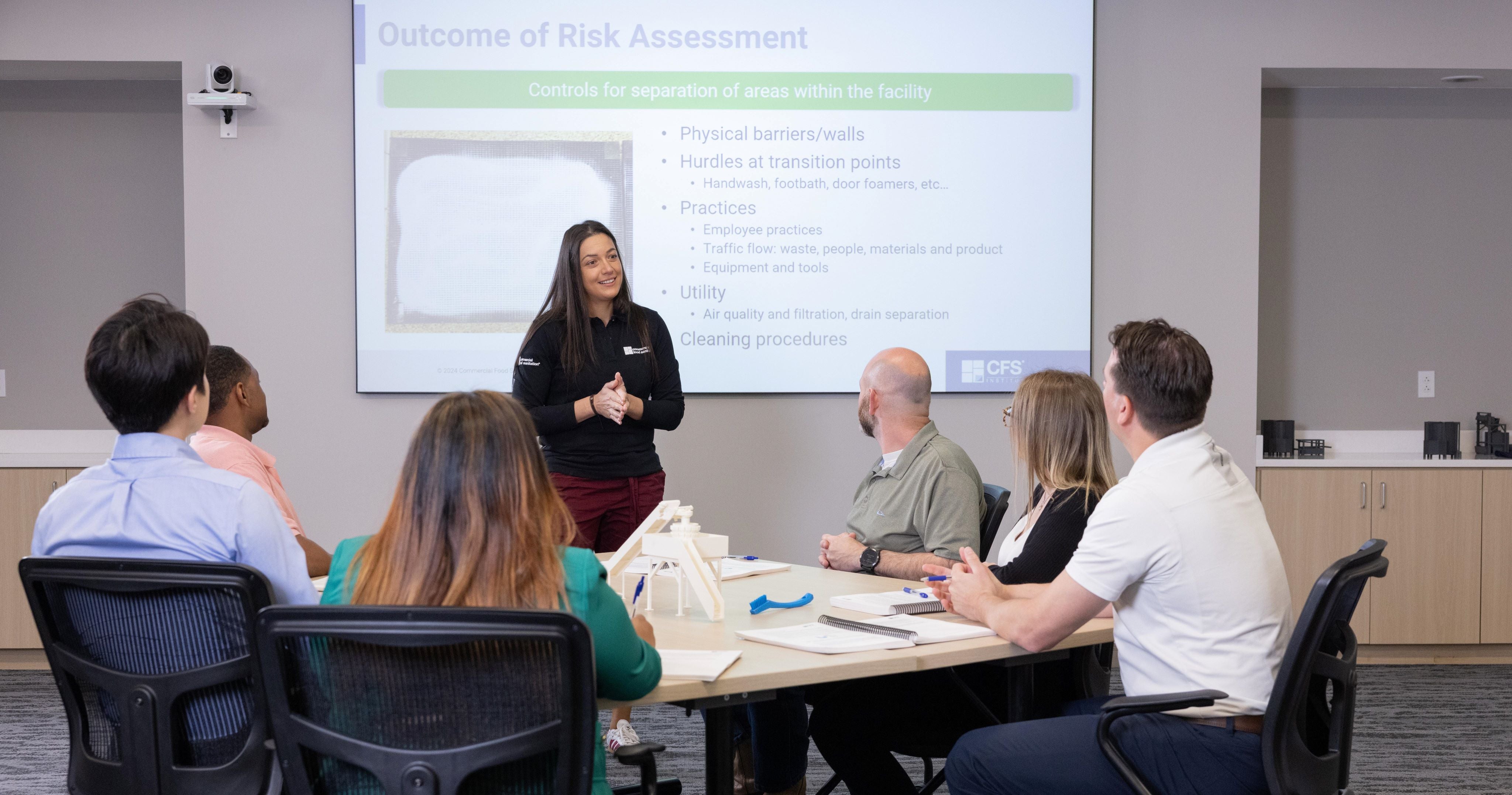 Female trainer in classroom explaining risk assessment