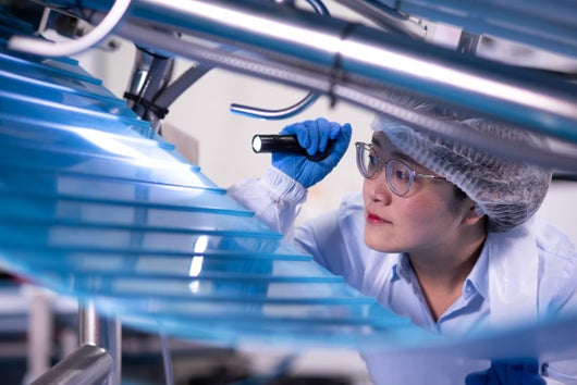Woman inspecting conveyor