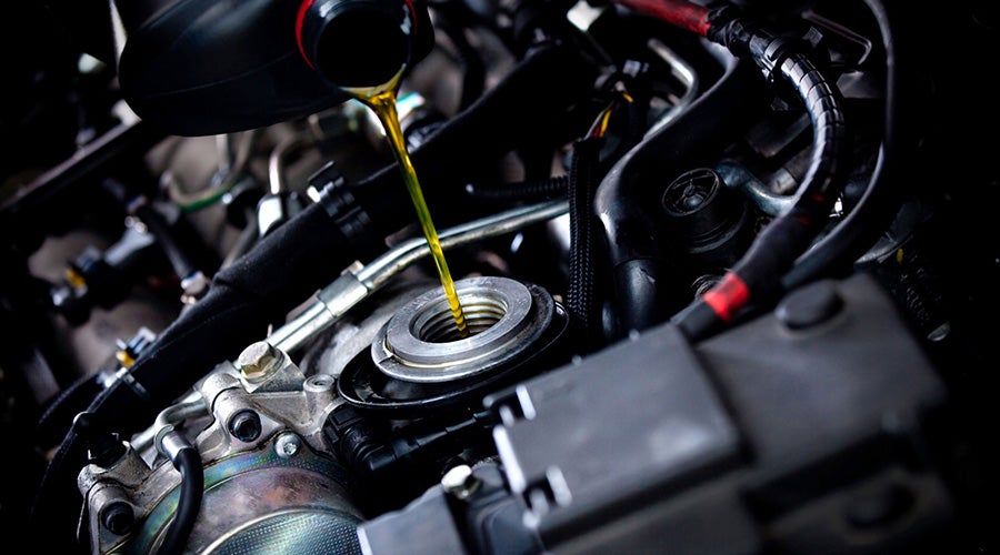 A oil pouring into a car engine