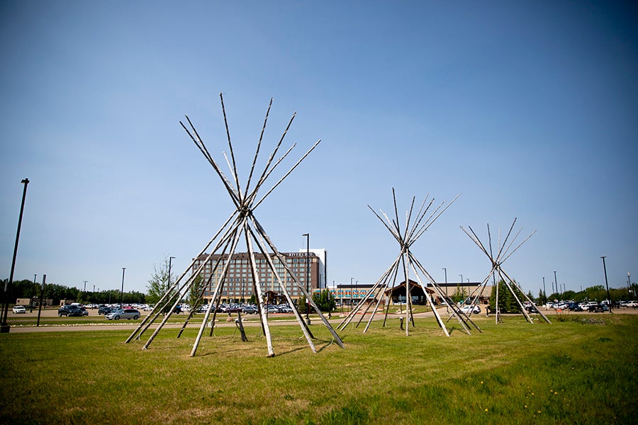 A group of teepees in a field