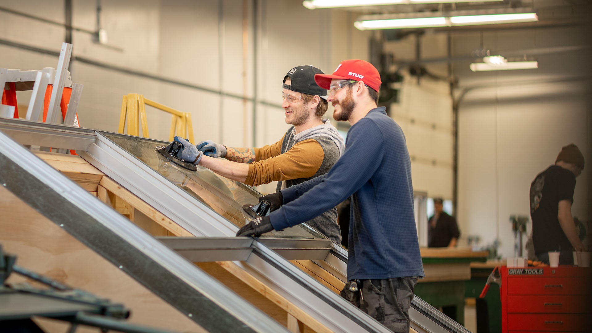 Two men working on a window