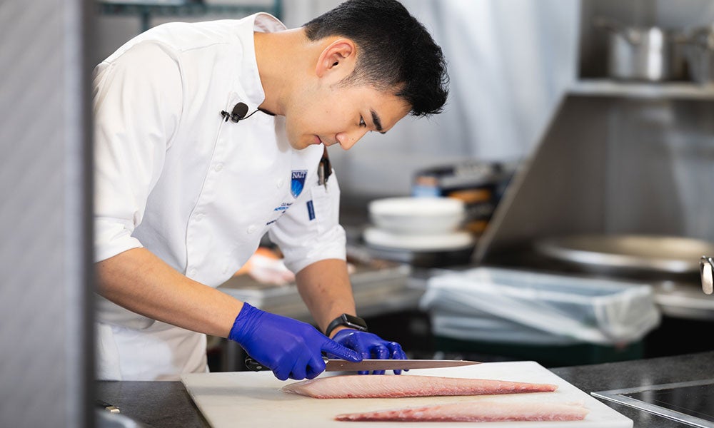 A man cutting meat on a cutting board