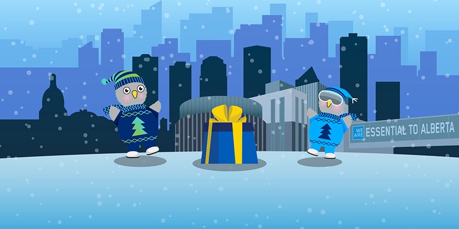 Two penguins in sweaters and hats with a gift in front of a city