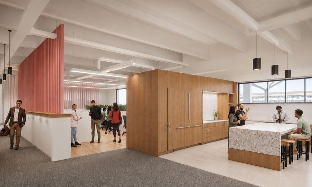 Architectural rendering of an open collaborative workspace featuring wood finishes, meeting areas, a central counter with seating, and people gathered throughout a bright interior.