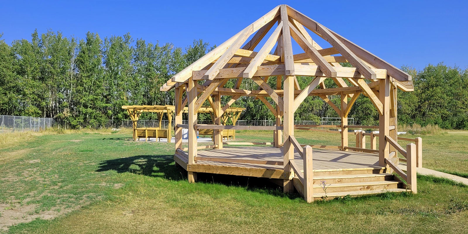 A wooden structure in a grassy area