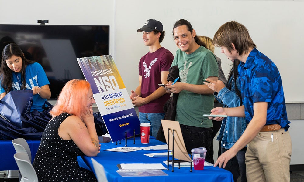 A group of people standing around a table