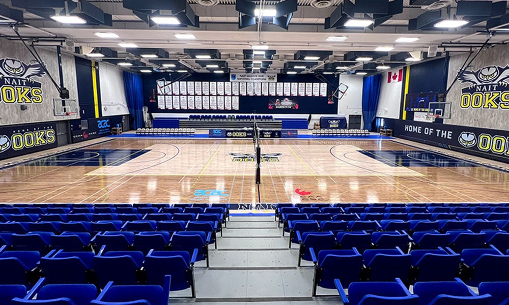 A basketball court with blue seats