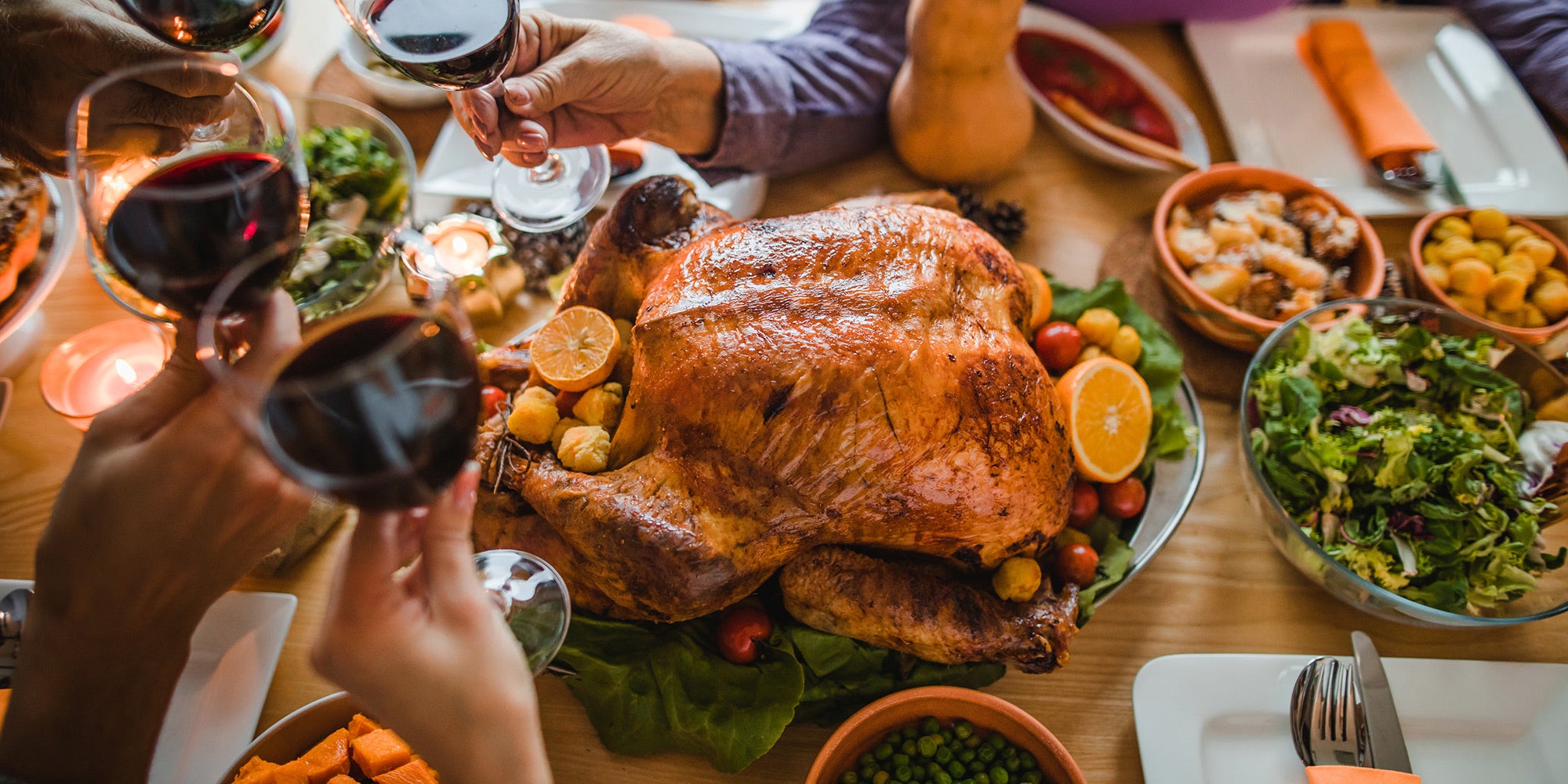 A turkey on a platter with wine glasses