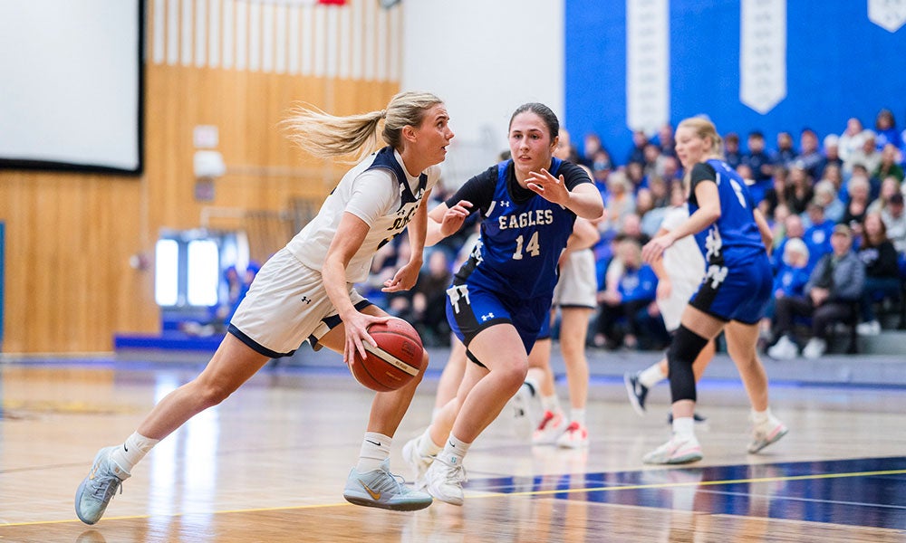 A group of women playing basketball