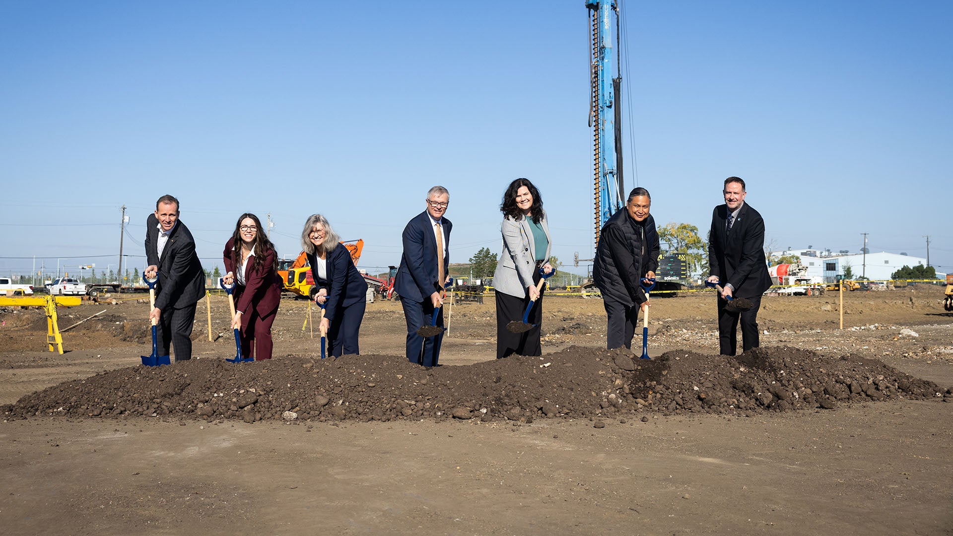 Speakers at the NAIT Advanced Skills Centre groundbreaking with shovels in the ground.