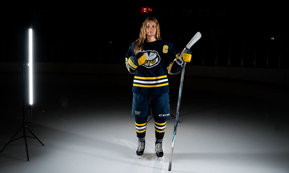 A woman holding a hockey stick