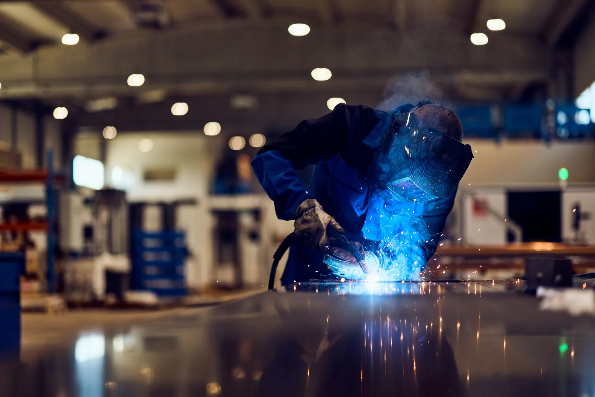 Welding metal in a workshop with bright sparks