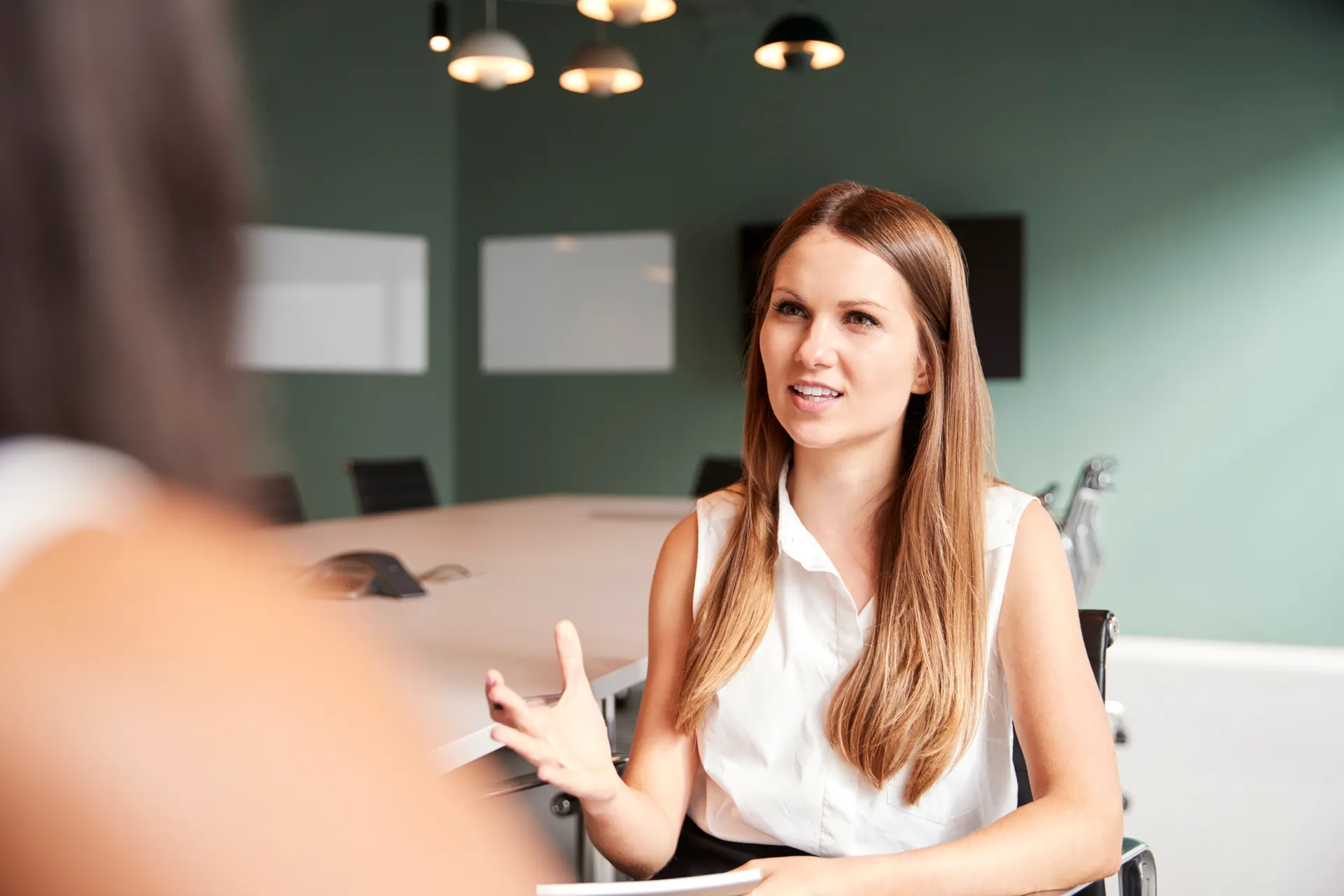 Businesswoman Interviewing Female Candidate At Graduate Recruitment Assessment Day In Office