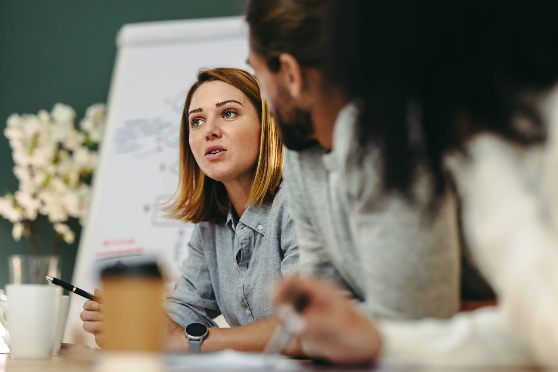 Woman in meeting explains idea